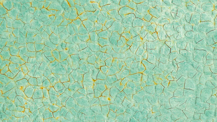 Cracked turquoise paint texture. Old crackled teal turquoise painted wood surface. Green turquoise painted cracked wall texture