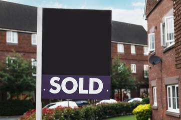 Sold property, sign near a house, UK