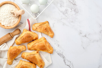 Fried empanadas with cilantro, meat, egg, tomato and chili sauce on white background. Latin American and Chilean independence day concept.