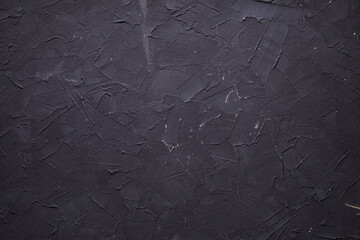 Abstract black painted wall background texture . Concrete or plaster surface of putty wall