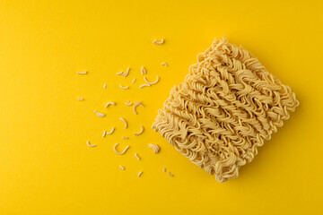 Dry instant noodles on yellow background.