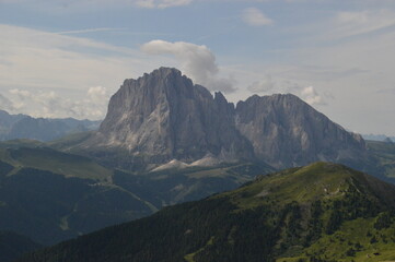 Fototapeta premium Taking in the stunning mountain views from a steep ridge in the Dolomites 