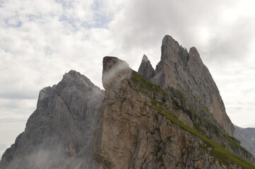 Fototapeta na wymiar Taking in the stunning mountain views from a steep ridge in the Dolomites 