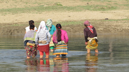 Women crossing a river in rural Nepal 