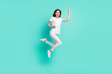 Fototapeta na wymiar Full size photo of hooray brunette hair young lady jump wear white t-shirt jeans isolated on teal color background