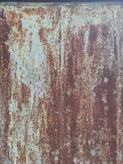 Texture of old painted rusty metal with faded peeling paint.