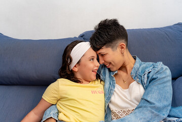 Portrait of latin mother and daughter at home.