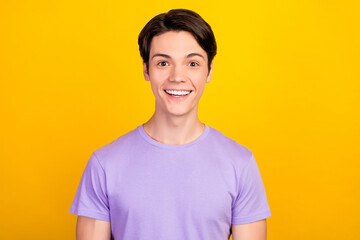 Portrait of attractive cheerful amazed guy good news sincere reaction isolated over bright yellow color background
