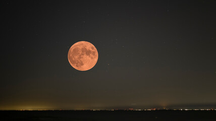 Fototapeta na wymiar A brilliant moon on a starry night