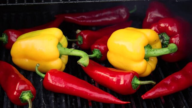 Cooking red and yellow bell peppers on grill