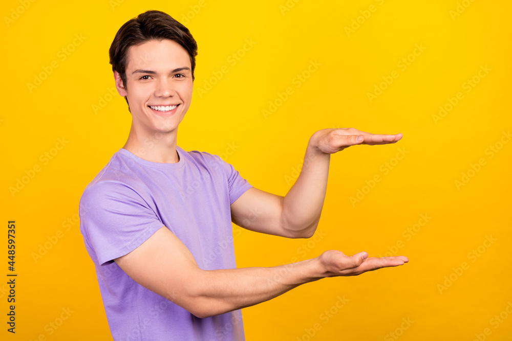 Sticker portrait of attractive cheerful guy demonstrating copy empty blank space invisible thing isolated ov