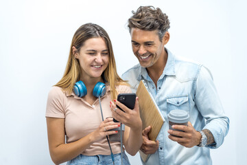 Fototapeta premium two smiling colleagues showing photo on smart phone 