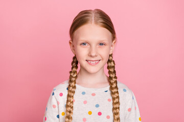 Photo of charming adorable schoolgirl dressed dotted sweater smiling isolated pink color background