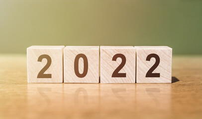 2022 word written on wooden blocks on wooden table. Concept for your design.