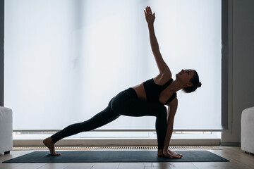 Woman doing crescent lunge with extended hands