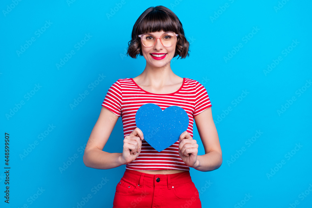 Canvas Prints Photo portrait girl in glasses smiing showing heart isolated vivid blue color background