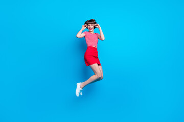 Fototapeta na wymiar Full length body size photo girl jumping up careless smiling happy cheerful isolated vibrant blue color background