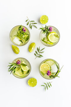 Fresh cold beverage with summer herbs and lemon in glasses