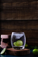 drink with lemon slices on parota wooden cup holders