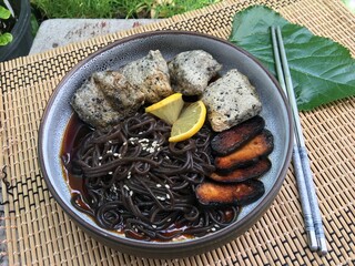 Black noodles, fried sesame tofu and fried soy tofu with soy and lemon sauce