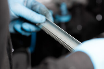 Detail from a toner cartridge. The blade is in the hands of an engineer of the service center for servicing the printing device.