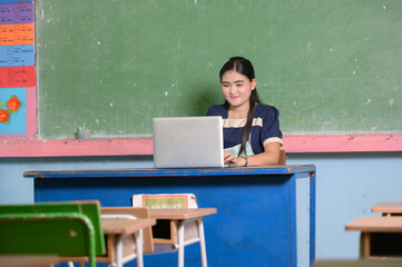 Asian female teachers teaching students online on a computer screen using an online video conferencing system for education.