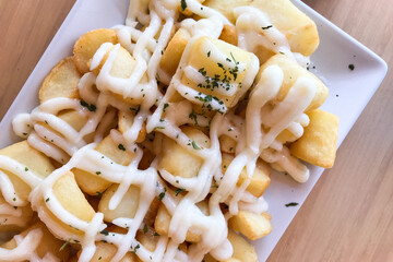 Alioli potatoes on a white plate in Spanish tapas bar