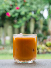 ice tea or ice thai tea in glass , fresh dessert in coffee cafe with nature background
