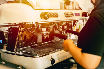 Barista working in cafe with Italian Espresso machine make a coffee image vintage tone.