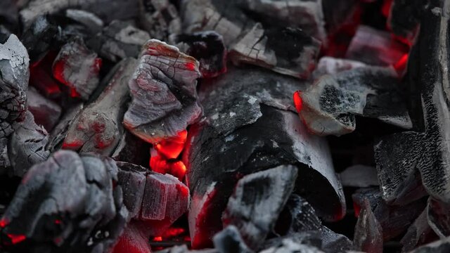 Blowing red hot aglow coals in barbecue grill