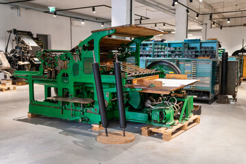 Old typography printing machine with letter samples. Mechanical printing process.