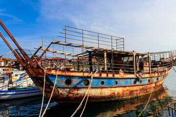 Fototapeta na wymiar Old rusty and abandoned ship in a port in Nessebar, Bulgaria
