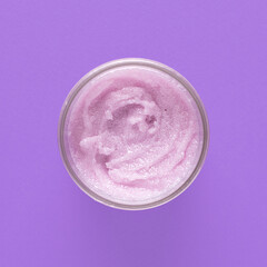 Cosmetic scrub for face and body on a lilac background. Beauty concept. Body treatment. Skin care.Top view. Selective focus.