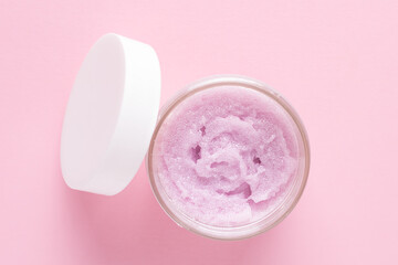 Cosmetic scrub for face and body on a pink background. Beauty concept. Top view.
