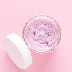 Cosmetic scrub for face and body on a pink background. Beauty concept. Body treatment. Skin care. Top view. Flat lay.