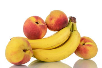 Naklejka na ściany i meble Several ripe bananas and peaches, close-up, isolated on white.