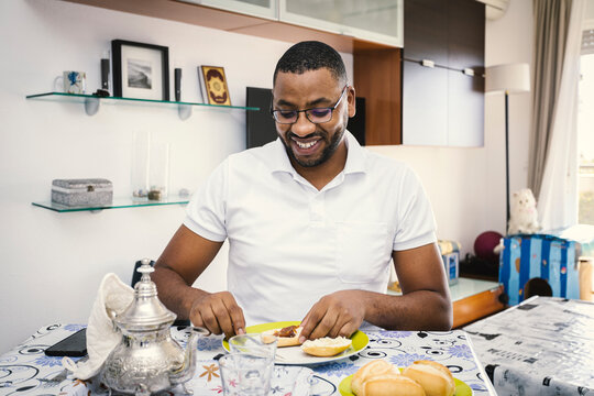 A Muslim Arab man has breakfast at home