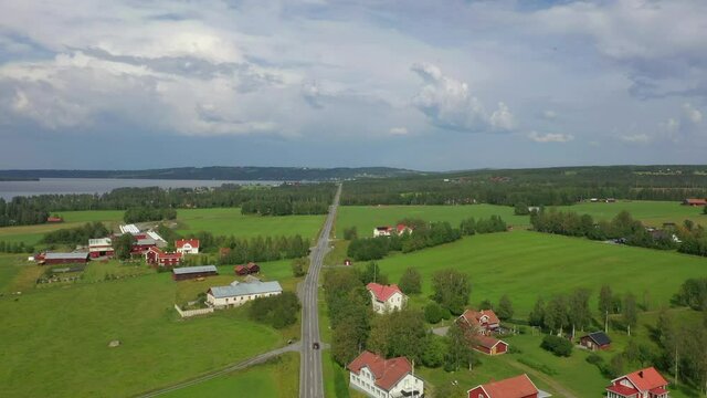 Aerial view of a car driving on a road in northern Sweden