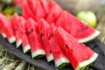 Sliced ripe watermelons are lying on a plate