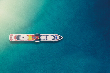Cruise ship in the blue sea, view from the top.