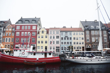 Fototapeta na wymiar DENMARK, COPENHAGEN: Scenic cityscape view of architecture along the canals with boats