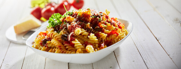 Bowl of pasta puttanesca in restaurant