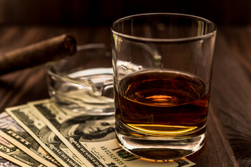 Glass of the whiskey with cigar