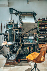 Old typography printing machine with letter samples. Mechanical printing process.