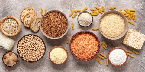 Fototapeta na wymiar Selection of gluten free food. A variety of grains, flours, pasta, and bread gluten-free on a rustic background. Top view, flat lay,wide composition.