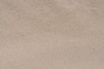Close-up of beige natural soft sand on the beach 