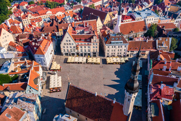 Medieval Tallinn, aerial view on the bright roofs of the old city with a drone, the main square of the city.