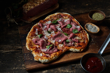Tasty pizza with meat on wooden table