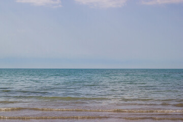 Morning scenery lakeside scenery: coastline, summer sky and waving water of the lake