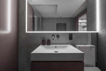 Modern minimalist bathroom interior design with grey stone tiles